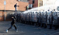 Nationalist youths and police in riot gear clash in the Ardoyne area of north Belfast 12 July, 2011
