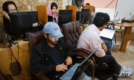 Customers use computers at an internet cafe in Tehran