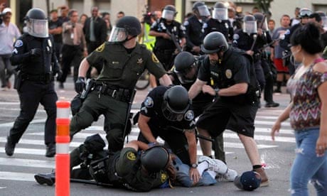 A protester is arrested by police officers from Orange County