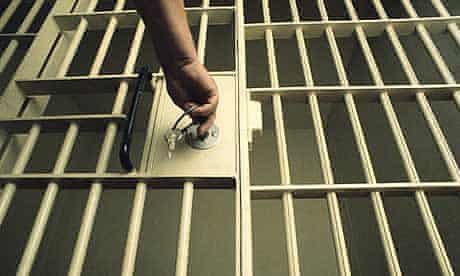 Locking a prison cell door.  