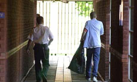 A prison officer accompanies a young offender at HMP Feltham B. 