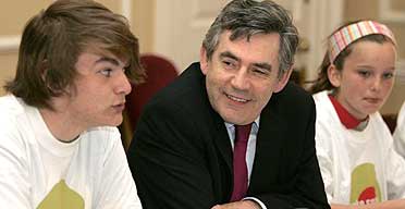 Prime minister Gordon Brown sits with Wilf Petheridge, youth mayor for Lewisham, and Eliza Gimson in a youth cabinet meeting in Downing Street.