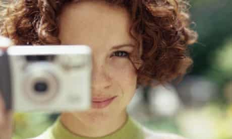 A woman uses a camera