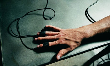 Lie detector close-up. Person's hand hooked up to polygraph test. Photograph: Seth Joel/Getty Images