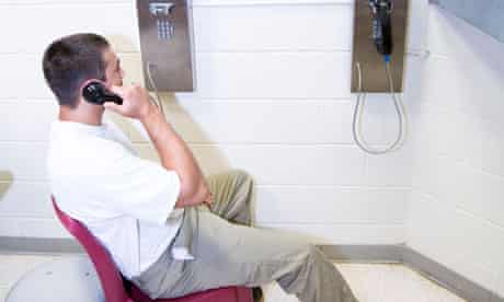 Prisoners in housing unit using the phone. Phone calls to and from prisoners are monitored by staff.