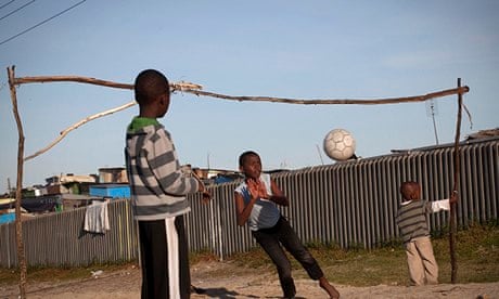 Children play by Khayelitsha township near Cape Town