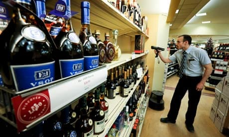An LCBO employee checks the stock at the Queens Quay liquor store in Toronto.