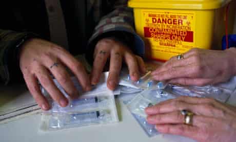 Sterile syringes being distributed to a drugs user as part of the needle exchange programme