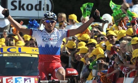 Serguei Ivanov of Russia celebrates as he crosses the finish line after winning the 14th stage