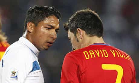 David Villa and Emilio Izaguirre confront each other during Spain's 2-0 win againnst Honduras