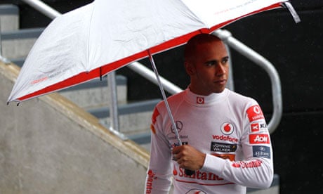 Lewis Hamilton walks in the pitlane during the second practice session for the British Grand Prix