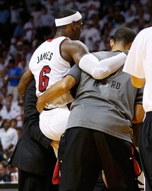 NBA4: Miami Heat's LeBron James is helped off the court