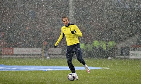 Tottenham's Harry Kane warms up in the snow before the start of the Capital One Cup semi-final again