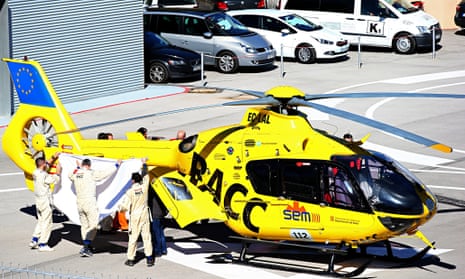Fernando Alonso is transferred from the medical centre to a helicopter after crashing in F1 testing