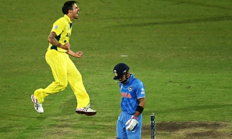 Mitchell Johnson of Australia celebrates taking the wicket of Virat Kohli