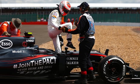 Jenson Button climbs out of his car after retiring on the first lap of the British Grand Prix 