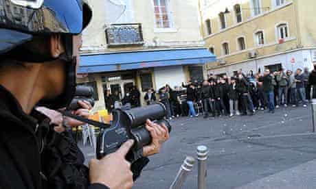 Riot police confront Paris St Germain fans in the streets of Marseille