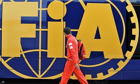 A team member of Ferrari walks in front of the FIA motorhome at Silverstone