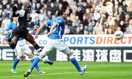 Newcastle United's Demba Ba heads the ball towards goal