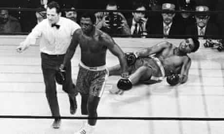 Joe Frazier is directed to the ropes by referee Arthur Marcante after knocking down Muhammad Ali