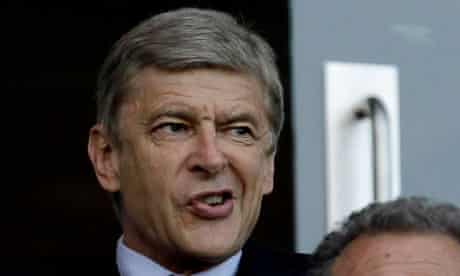 Arsene Wenger watches Arsenal's Champiions LEague qualifying match against Udinese from tehr stands