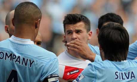 The QPR midfielder and captain Joey Barton clashes with Manchester City's Vincent Kompany