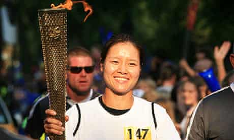 Chinese tennis player Li Na carries the Olympic flame through north London on Wednesday