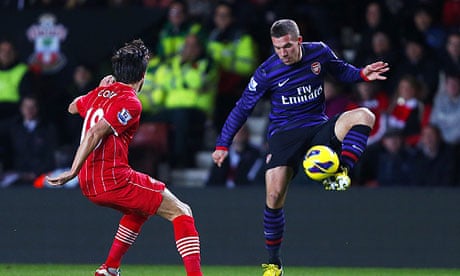 Lukas Podolski, right, looks to retain possession under pressure from Southampton's Jack Cork