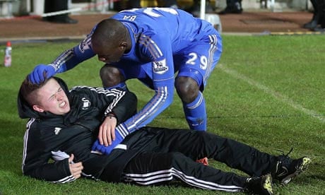 Chelsea's Demba Ba checks on the ballboy Charlie Morgan after the boy had clashed with Eden Hazard.