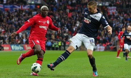 Wigan's Arouna Koné and Mark Beevers of Millwall compete for the ball, FA Cup semi-final