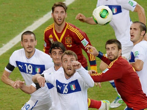 Italian and Spanish players keep an eye on the ball