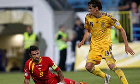 Denys Gamesh, left, challenges Mirko Vucinic during Ukraine's victory over Montenegro in Podgorica