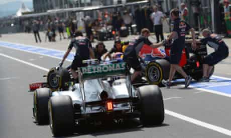Mechanics push Mark Webber's car
