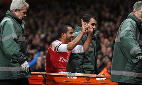 Theo Walcott gestures to the away fans during Arsenal's 2-0 victory over Tottenham on Saturday