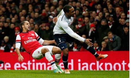Pain is etched on Theo Walcott's face as he goes down injured after a challenge with Danny Rose.