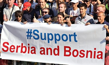 Novak Djokovic (4-R) poses for a photo with a banner reading "#support Serbia and Bosnia"
