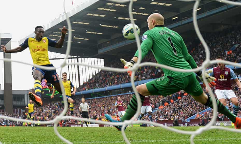 Danny Welbeck beats Aston Villa's goalkeeper Brad Guzan to score his first goal for Arsenal.