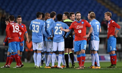 Lazio and Napoli players surround referee Massimiliano Irrati as he halts their match in Rome