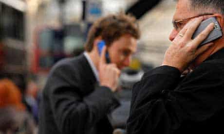 Two businessmen using mobile phones