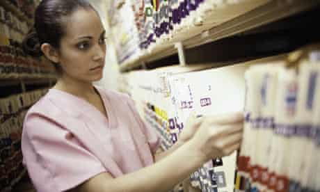 Nurse Looking Through Medical Records