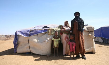 Zicki Fli and family outside their tent 