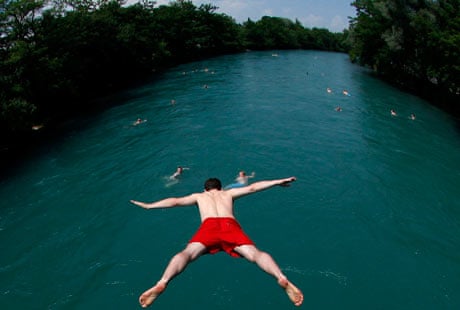 A swimmer jumps into the river Aare