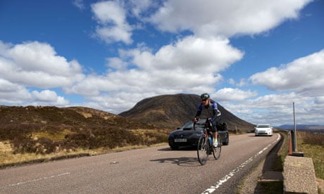 Cyclist on the A82 road in Glen Coe in the Scottish Highlands 