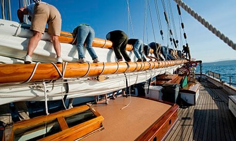 All hands on deck … crew members put away the sails.