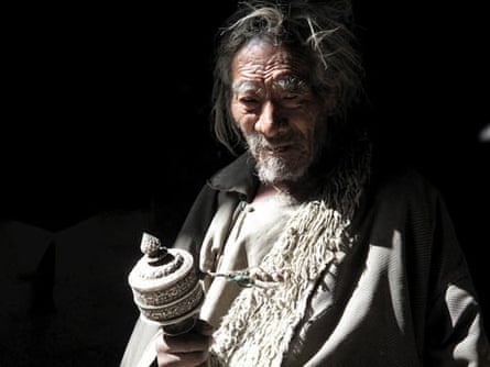 A Himalayan villager with a Tibetan prayer wheel.