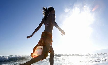 A young woman running on Santa Monica beach