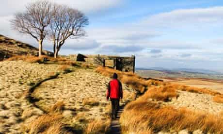 Walker on The Bronte Way at Top Withins, Haworth Moor, West Yorkshire