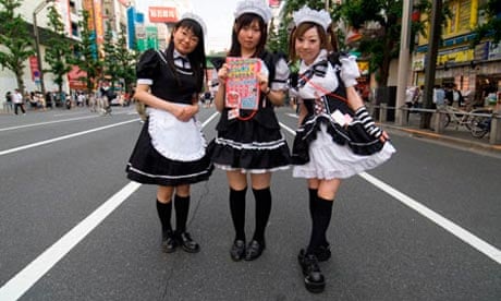 Costumed girls advertising a maid cafe in Tokyo.