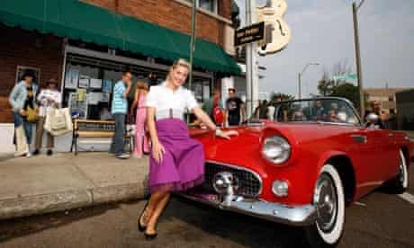 An Elvis fan poses with a convertible in front of Sun Studios in Memphis, Tennessee