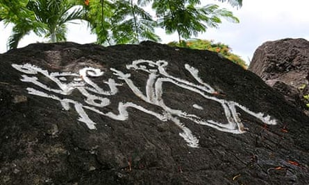 Petroglyphs on black rock in St Kitts.